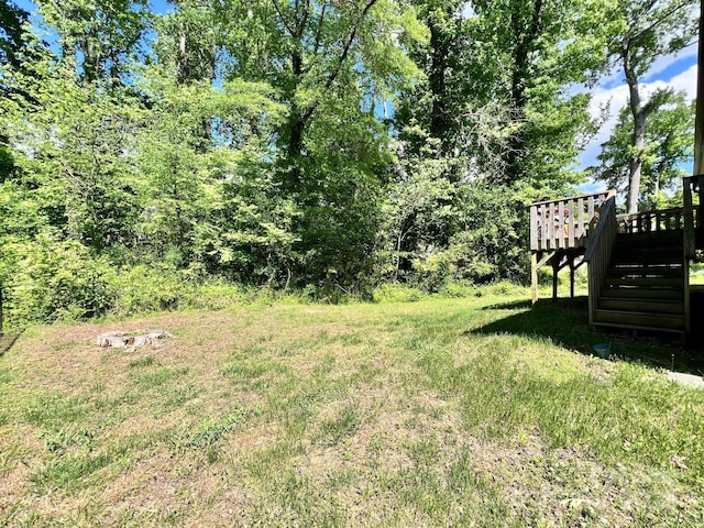 view of yard featuring a deck and stairs