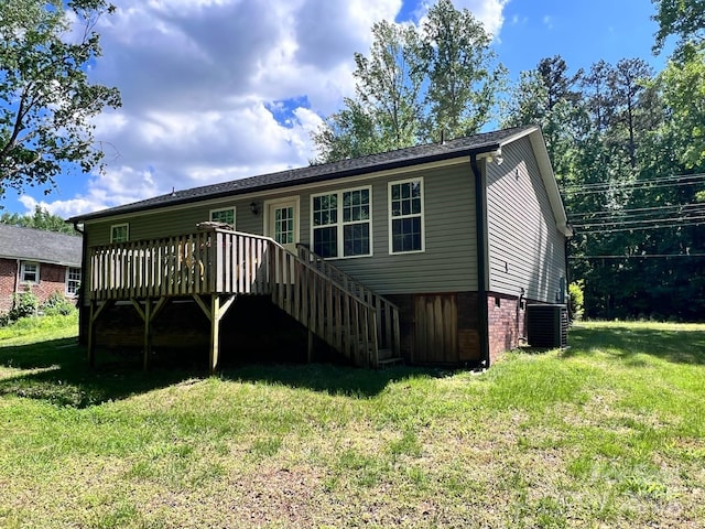 back of house featuring central AC unit, a deck, stairs, and a yard