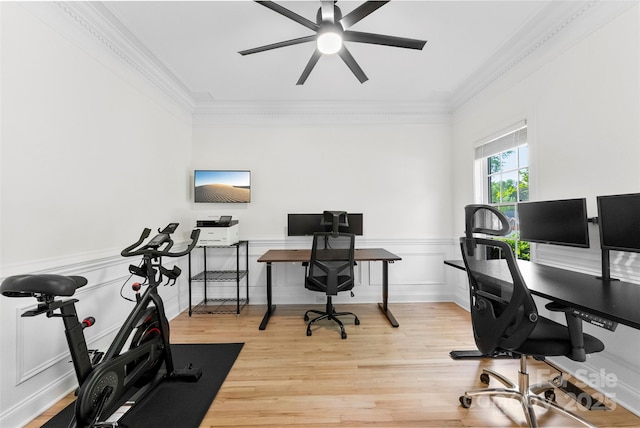 office space featuring ornamental molding, ceiling fan, wainscoting, and wood finished floors