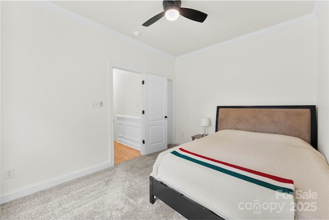 bedroom with crown molding, carpet flooring, a ceiling fan, and baseboards