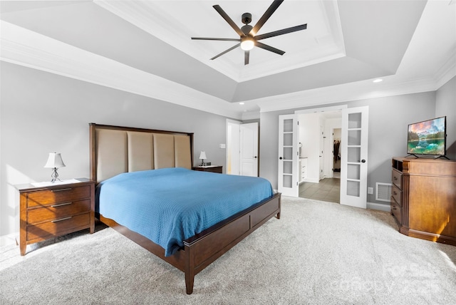 carpeted bedroom featuring recessed lighting, ornamental molding, french doors, and a tray ceiling