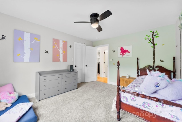carpeted bedroom with ceiling fan and baseboards