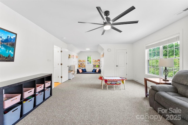 recreation room with visible vents, a ceiling fan, baseboards, and carpet floors