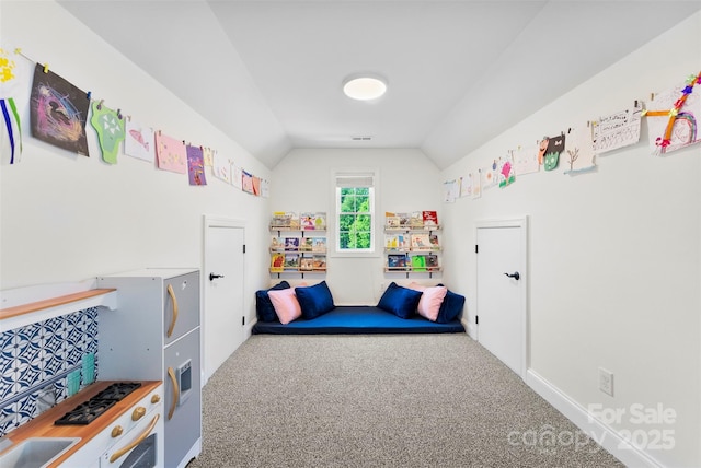 bedroom with carpet, vaulted ceiling, and baseboards