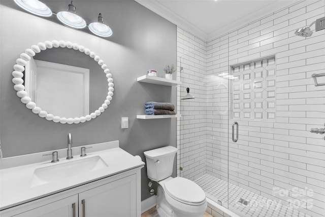 full bath featuring a shower stall, toilet, crown molding, and vanity