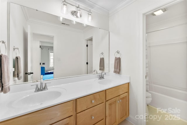 ensuite bathroom featuring visible vents, toilet, double vanity, and a sink