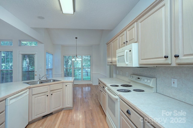 3226 Chatfield Ln SW, Concord, NC 28027 - kitchen with light countertops, a sink, white appliances, a chandelier, and light wood-style flooring