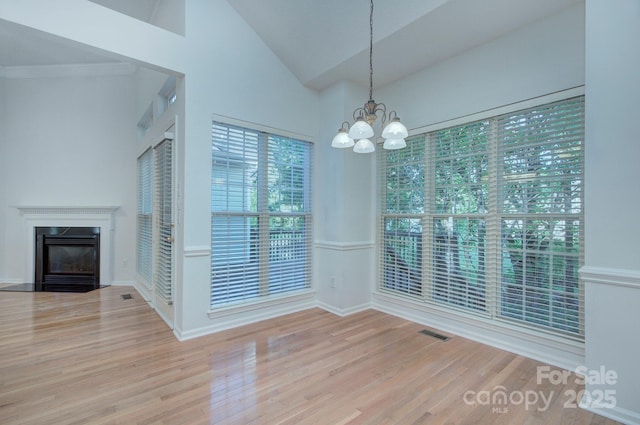 3226 Chatfield Ln SW, Concord, NC 28027 - unfurnished dining area with a notable chandelier, wood finished floors, visible vents, and a fireplace