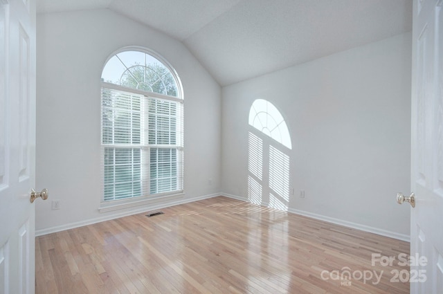 3226 Chatfield Ln SW, Concord, NC 28027 - empty room with wood-type flooring, lofted ceiling, and visible vents