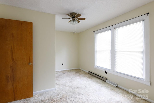 carpeted empty room with ceiling fan, baseboards, and visible vents