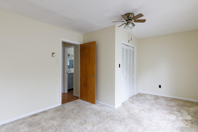 empty room with carpet, baseboards, and ceiling fan