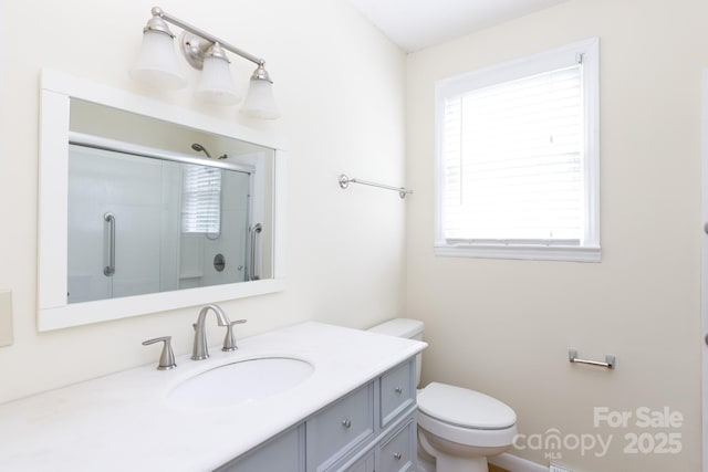 full bath featuring toilet, an enclosed shower, and vanity