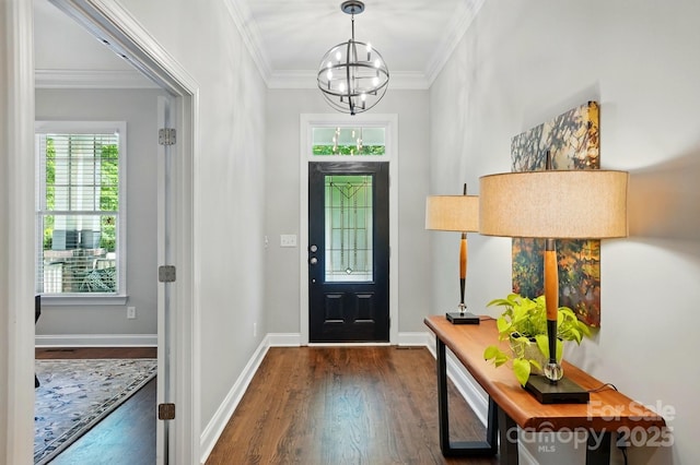 entrance foyer featuring a chandelier, baseboards, dark wood finished floors, and ornamental molding