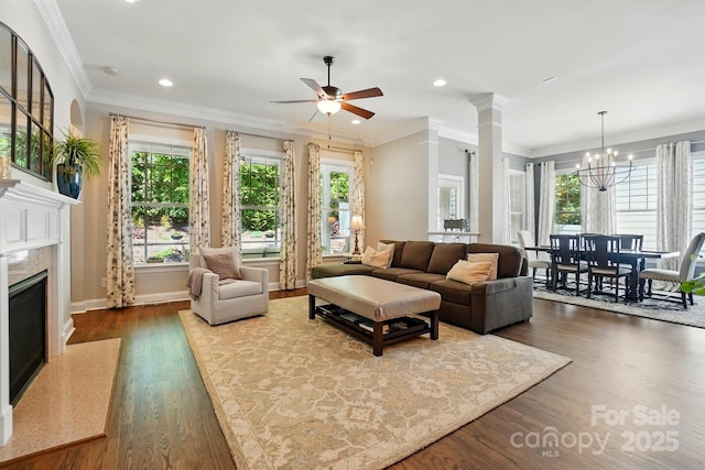 living room featuring recessed lighting, dark wood-style flooring, baseboards, and a premium fireplace