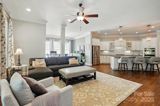 living area with crown molding, dark wood-style flooring, baseboards, recessed lighting, and a ceiling fan
