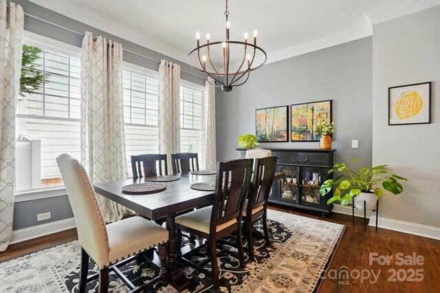 dining area featuring baseboards, wood finished floors, and a notable chandelier