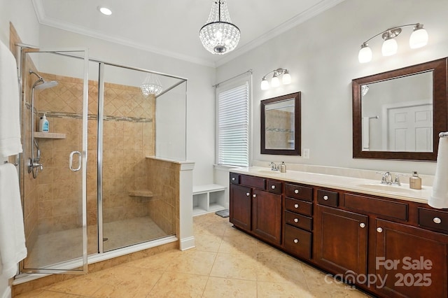 full bath with a sink, an inviting chandelier, ornamental molding, and a stall shower