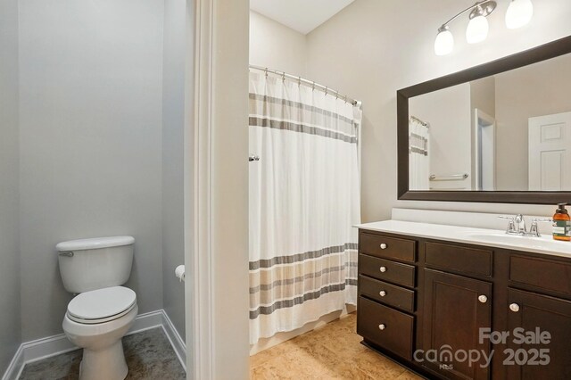full bathroom with vanity, toilet, tile patterned floors, baseboards, and a shower with curtain