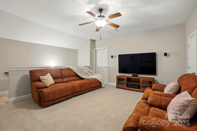 carpeted living room with baseboards, vaulted ceiling, and ceiling fan