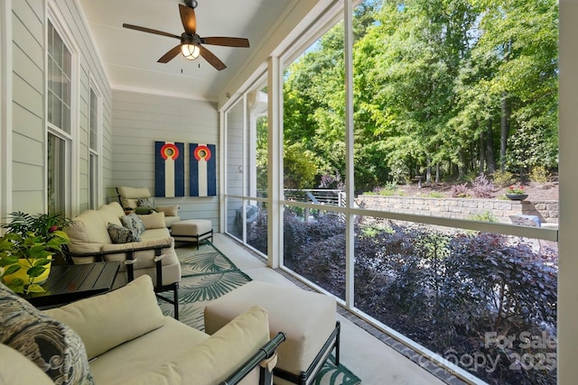 sunroom featuring an outdoor living space and ceiling fan