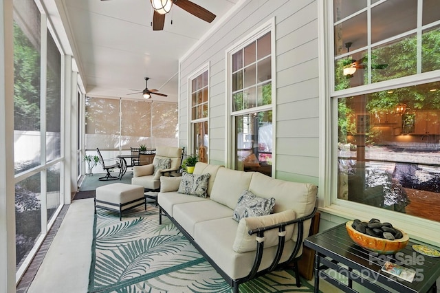 sunroom featuring outdoor lounge area, a ceiling fan, and a wealth of natural light