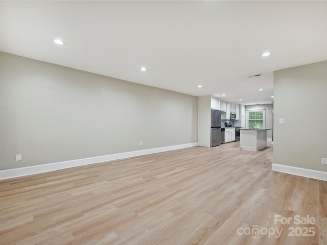 7004 Quail Hill Rd, Charlotte, NC 28210 - unfurnished living room with baseboards, visible vents, light wood-style floors, and recessed lighting
