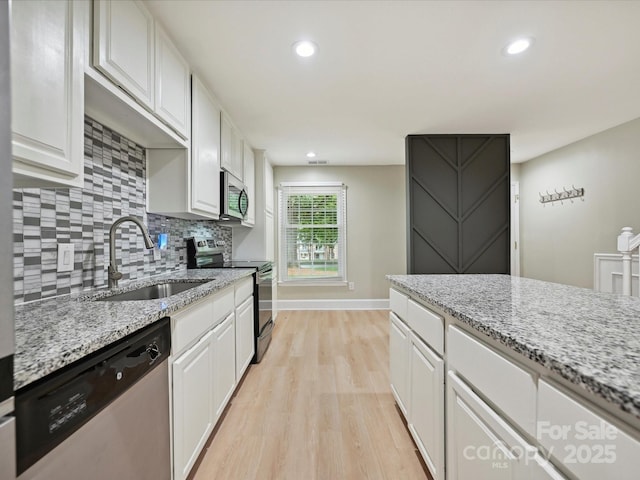 7004 Quail Hill Rd, Charlotte, NC 28210 - kitchen featuring a sink, white cabinetry, stainless steel appliances, and light wood-type flooring