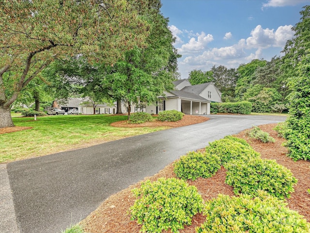 7004 Quail Hill Rd, Charlotte, NC 28210 - obstructed view of property featuring a front lawn, a garage, and aphalt driveway