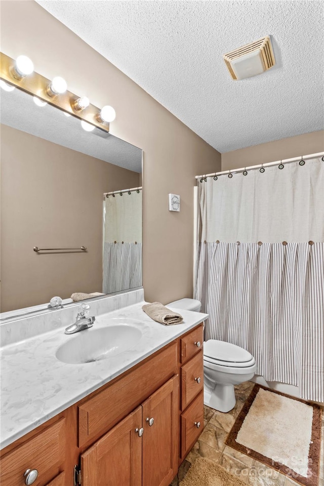 full bath with a textured ceiling, visible vents, toilet, and vanity