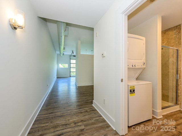 1611 Central Ave Unit 406, Charlotte, NC 28205 - hallway with baseboards, stacked washer / dryer, and wood finished floors