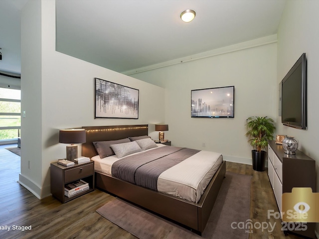 1611 Central Ave Unit 406, Charlotte, NC 28205 - bedroom featuring baseboards and dark wood-type flooring