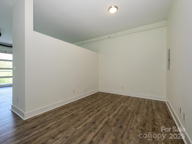 1611 Central Ave Unit 406, Charlotte, NC 28205 - empty room with electric panel, baseboards, and dark wood-type flooring