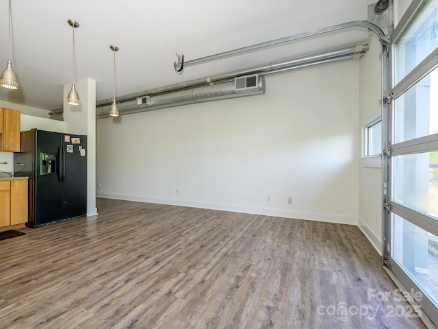 1611 Central Ave Unit 406, Charlotte, NC 28205 - interior space featuring wood finished floors, visible vents, a healthy amount of sunlight, and baseboards