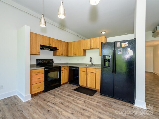 1611 Central Ave Unit 406, Charlotte, NC 28205 - kitchen featuring light wood-style floors, under cabinet range hood, black appliances, a sink, and baseboards