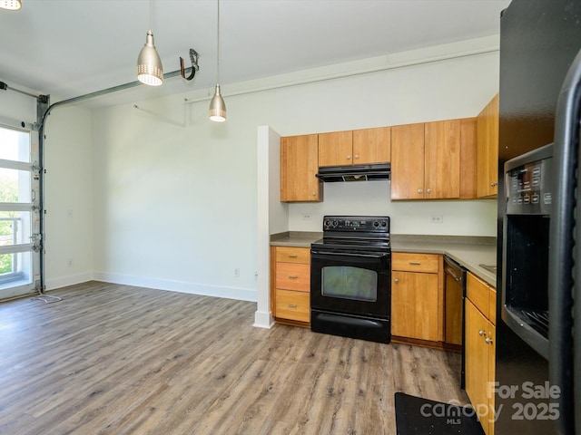 1611 Central Ave Unit 406, Charlotte, NC 28205 - kitchen featuring black appliances, brown cabinets, light wood finished floors, and under cabinet range hood