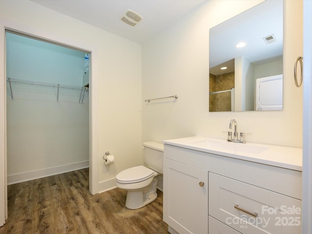 1611 Central Ave Unit 406, Charlotte, NC 28205 - bathroom with toilet, an enclosed shower, a walk in closet, visible vents, and wood finished floors