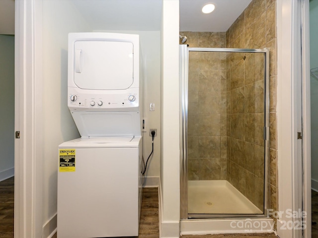 1611 Central Ave Unit 406, Charlotte, NC 28205 - full bath featuring baseboards, stacked washing maching and dryer, wood finished floors, and a shower stall