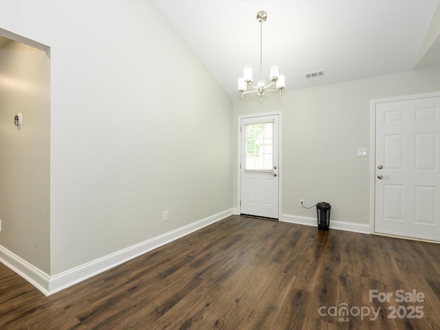 unfurnished dining area with dark wood finished floors, lofted ceiling, visible vents, baseboards, and a chandelier