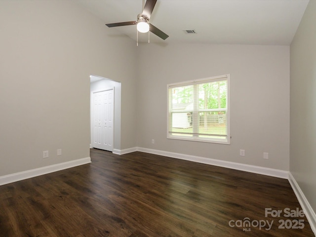 spare room featuring high vaulted ceiling, ceiling fan, baseboards, dark wood-style flooring, and visible vents