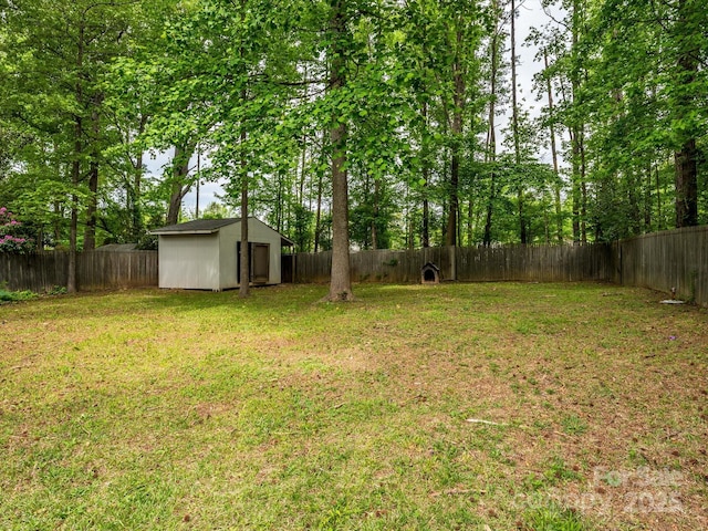 view of yard with a storage shed, an outbuilding, and a fenced backyard