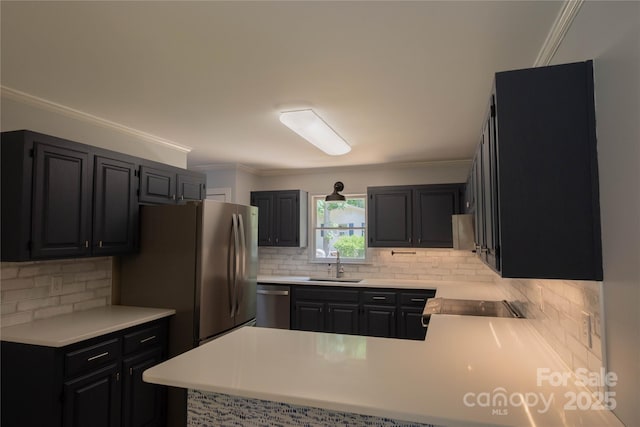432 Partridge Pl, York, SC 29745 - kitchen with a sink, appliances with stainless steel finishes, a peninsula, decorative backsplash, and ornamental molding