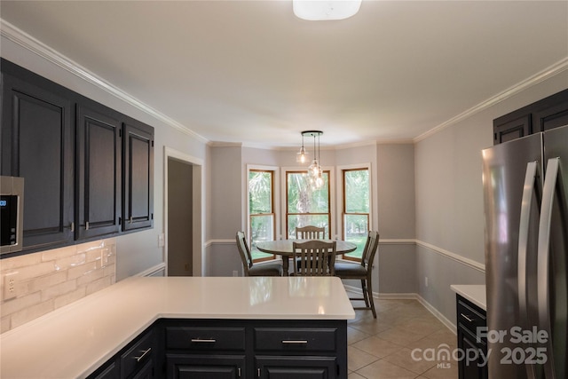 432 Partridge Pl, York, SC 29745 - kitchen featuring freestanding refrigerator, a peninsula, dark cabinetry, tasteful backsplash, and light countertops