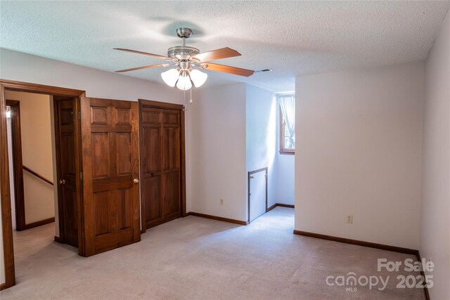 432 Partridge Pl, York, SC 29745 - unfurnished bedroom featuring light colored carpet, baseboards, a textured ceiling, and ceiling fan