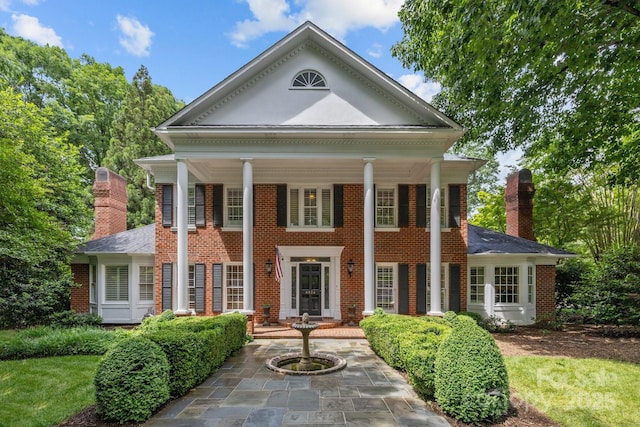 6824 N Baltusrol Ln, Charlotte, NC 28210 - greek revival house featuring a chimney, brick siding, and covered porch