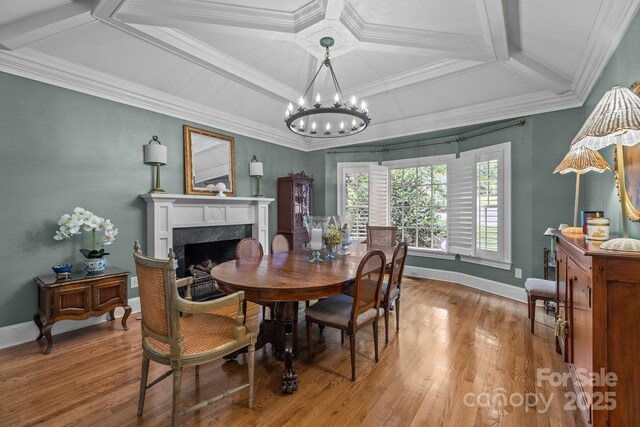 6824 N Baltusrol Ln, Charlotte, NC 28210 - dining space featuring a chandelier, a fireplace, light wood finished floors, coffered ceiling, and baseboards