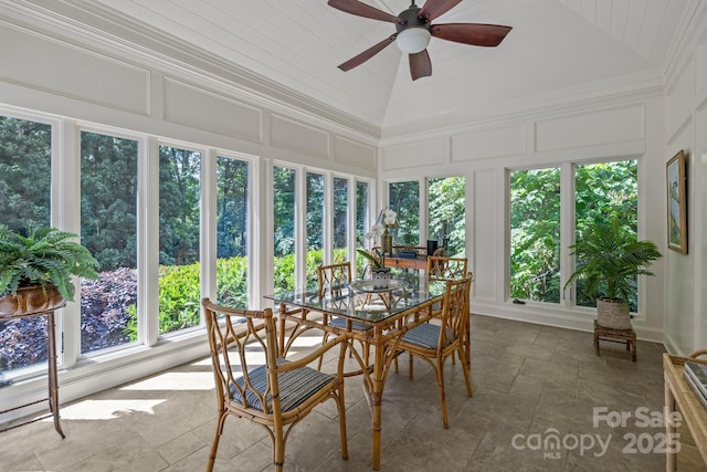 6824 N Baltusrol Ln, Charlotte, NC 28210 - sunroom with a decorative wall, vaulted ceiling, and stone finish floors