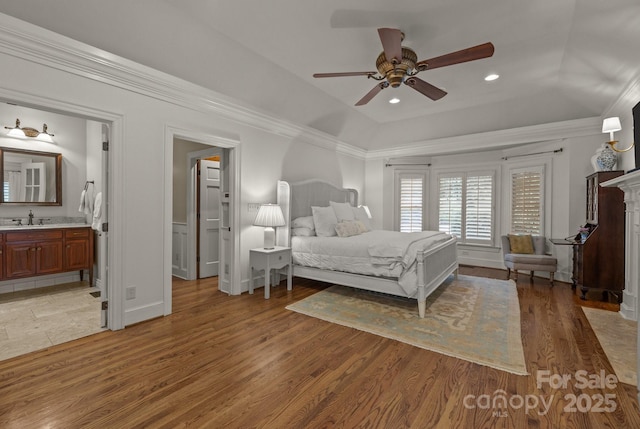 6824 N Baltusrol Ln, Charlotte, NC 28210 - bedroom featuring a sink, light wood-style floors, crown molding, a raised ceiling, and recessed lighting