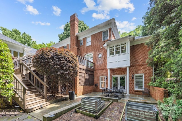 6824 N Baltusrol Ln, Charlotte, NC 28210 - back of property featuring brick siding, stairs, a patio area, a chimney, and french doors