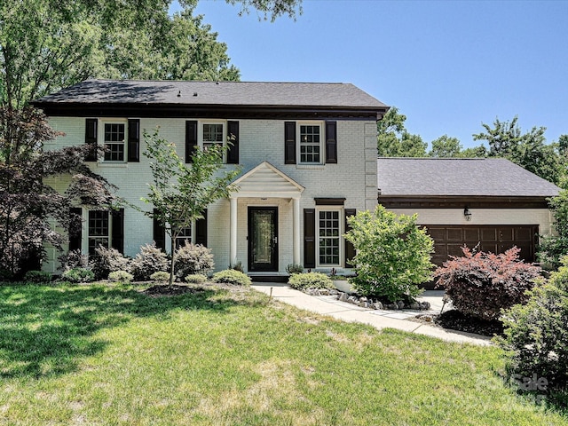 8200 Lansford Rd, Charlotte, NC 28277 - colonial home with brick siding, an attached garage, and a front yard