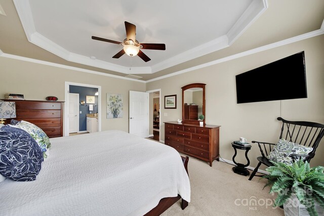 bedroom featuring ceiling fan, ornamental molding, carpet, and a raised ceiling